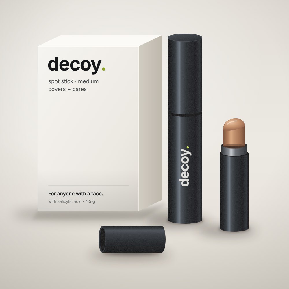 The Decoy spot stick: a matte black stick next to its white box, with a second stick open showing the tinted balm